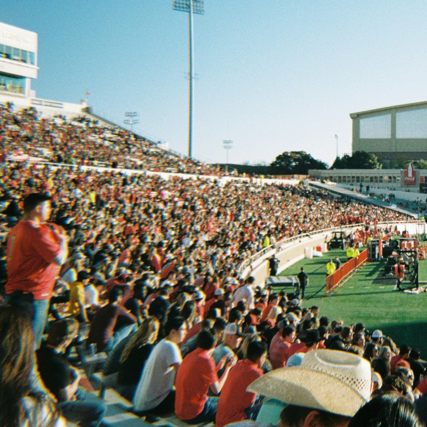 Fans filling the stands at a college football game